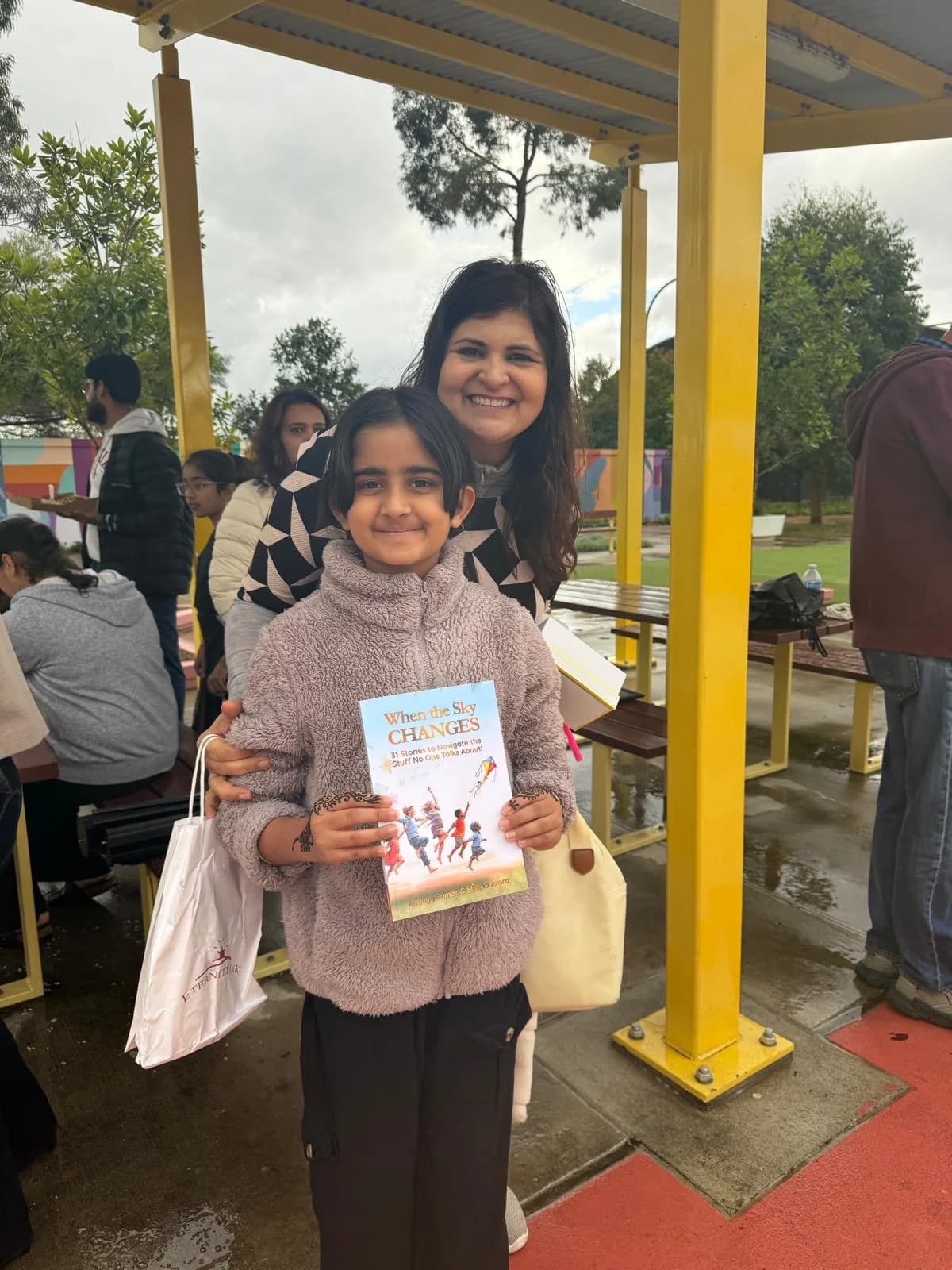 A young reader holding a copy of the book